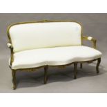 A 20th century Louis XV style giltwood showframe salon settee, upholstered in patterned cream