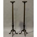 A pair of 19th century and later mahogany bedpost torchères with pierced fretwork galleries,