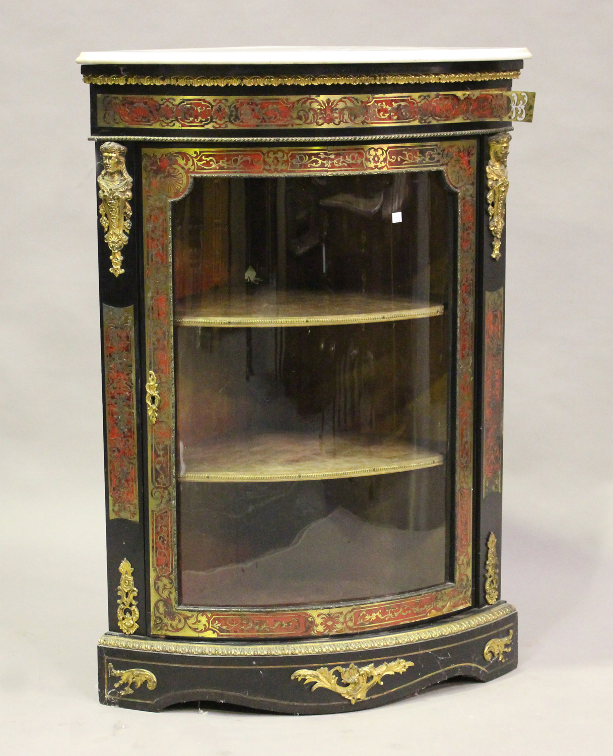 A mid/late 19th century ebonized boulle work corner display cabinet, the white marble top above a