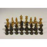 A 20th century boxwood Staunton chess set, one side stained, with weighted bases, height of king 9.