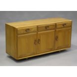 An Ercol pale elm sideboard fitted with drawers and cupboards, height 69cm, width 136cm, depth