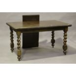 A George V oak extending dining table, the top with extra leaf, raised on barley twist legs,
