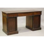 An early Victorian mahogany twin-pedestal desk, the frieze fitted with three drawers above