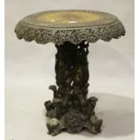 A late 19th century Burmese carved hardwood tip-top centre table, raised on a pierced quatrefoil