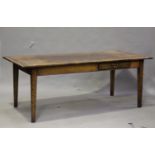 A 20th century reclaimed oak farmhouse table, the three-plank top above two frieze drawers, on