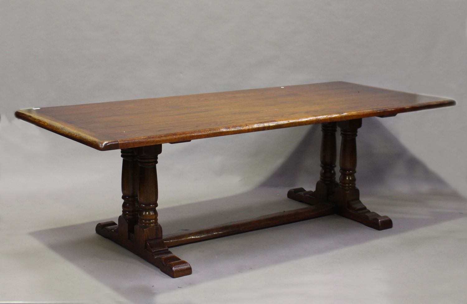 A modern Jacobean Revival oak refectory dining table by the Royal Oak Furniture Company, the seven-