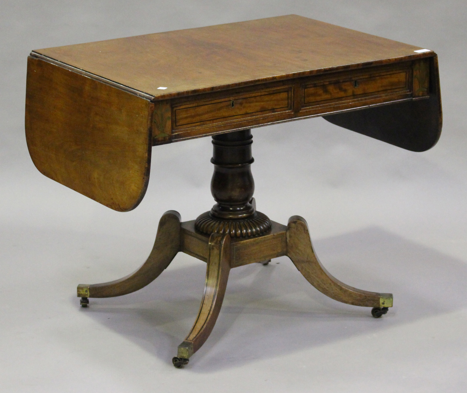 A Regency mahogany and brass inlaid sofa table with ebony stringing and oak-lined drawers, height