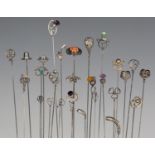 A selection of twenty-seven mainly early 20th century silver mounted hatpins, including examples