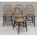 A set of four late 19th/early 20th century ash and elm hoop back kitchen chairs with turned