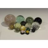 A group of polished spherical mineral specimens, including a large rose quartz, diameter 12cm, green
