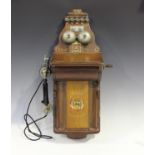 An early 20th century Belgian walnut cased wall telephone by Jydsk, height 71cm, width 25cm.Buyer’