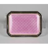 An early 20th century pink and black enamelled silver lady's compact, the gilded interior with