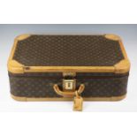 A late 20th century Louis Vuitton monogram canvas hard-sided travelling case, length 70cm (faults).