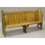An early 20th century pine pew with shaped ends, height 100cm, width 182cm.Buyer’s Premium 29.4% (