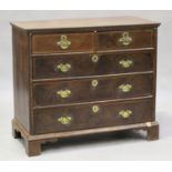 A George I and later walnut chest of two short and three long drawers with cross and feather