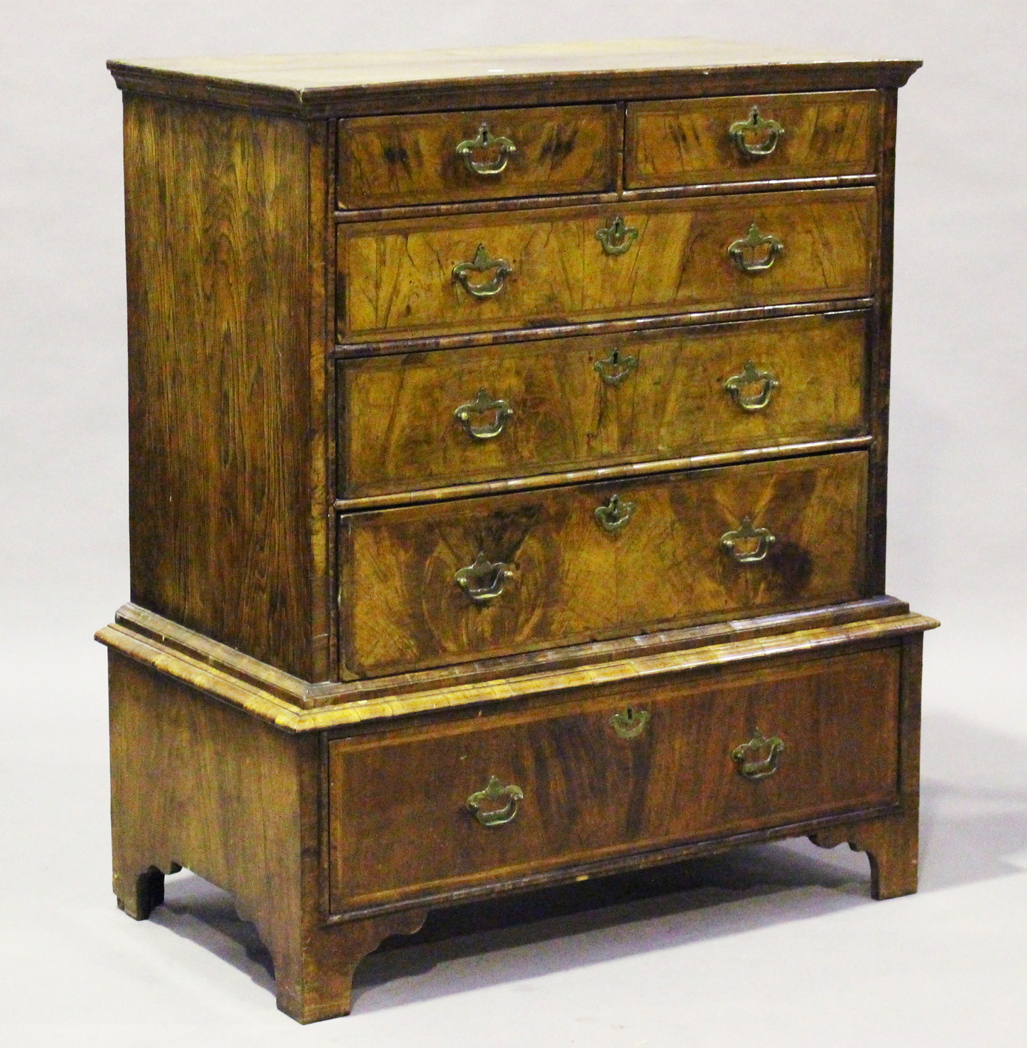 A George I walnut chest-on-stand with overall crossbanded borders, height 118cm, width 104cm,
