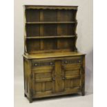 A 20th century Jacobean Revival oak dresser, height 192cm, width 127cm, depth 47cm.Buyer’s Premium