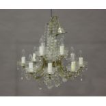 A pair of mid-20th century clear glass mounted twelve-light chandeliers, height 50cm, width 55cm,