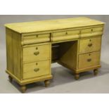 A late Victorian pine kneehole dressing table, fitted with seven drawers, height 78cm, width