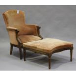 An early 20th century French walnut framed tub back armchair and matching stool, both with ribbon-