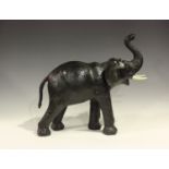 A 20th century leather model of an elephant, possibly retailed by Liberty & Co, height 48cm,