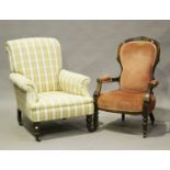 A late 19th/early 20th century scroll back armchair, on turned beech legs and castors, height