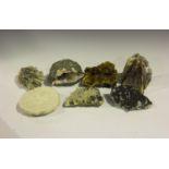 A selection of six mineral specimens, including a quartz geode, a yellow fluorite and merlinite,