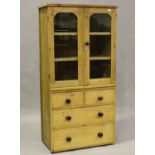 A Victorian pine narrow cabinet, fitted with two glazed doors above four drawers, height 167cm,