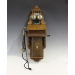 An early 20th century Swedish walnut cased wall telephone by L.M. Ericsson, height 65cm, width