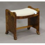 An Art Deco burr walnut piano stool, the drop-in seat upholstered in a palmette patterned fabric,