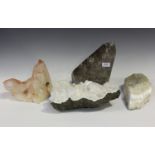 A group of four large mineral specimens, comprising a rose quartz formation, width 25cm, a section