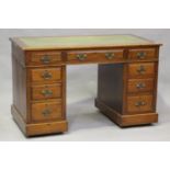 An Edwardian walnut twin-pedestal desk, the top inset with green leather, height 74cm, width