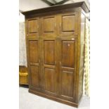 A large modern 18th century solid oak wardrobe by Bylaw, fitted with panelled doors enclosing