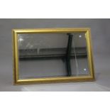 A pair of modern gilt framed mirrors with bevelled glass, 68cm, x 99cm, together with a matching