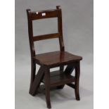 A 20th century hardwood metamorphic library chair, folding to form a set of steps, height 89cm,