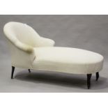 An early 20th century tub back chaise longue, upholstered in patterned damask, on ebonized legs,