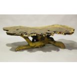 A 20th century redwood cross-section coffee table, the shaped burr top raised on a root base, height