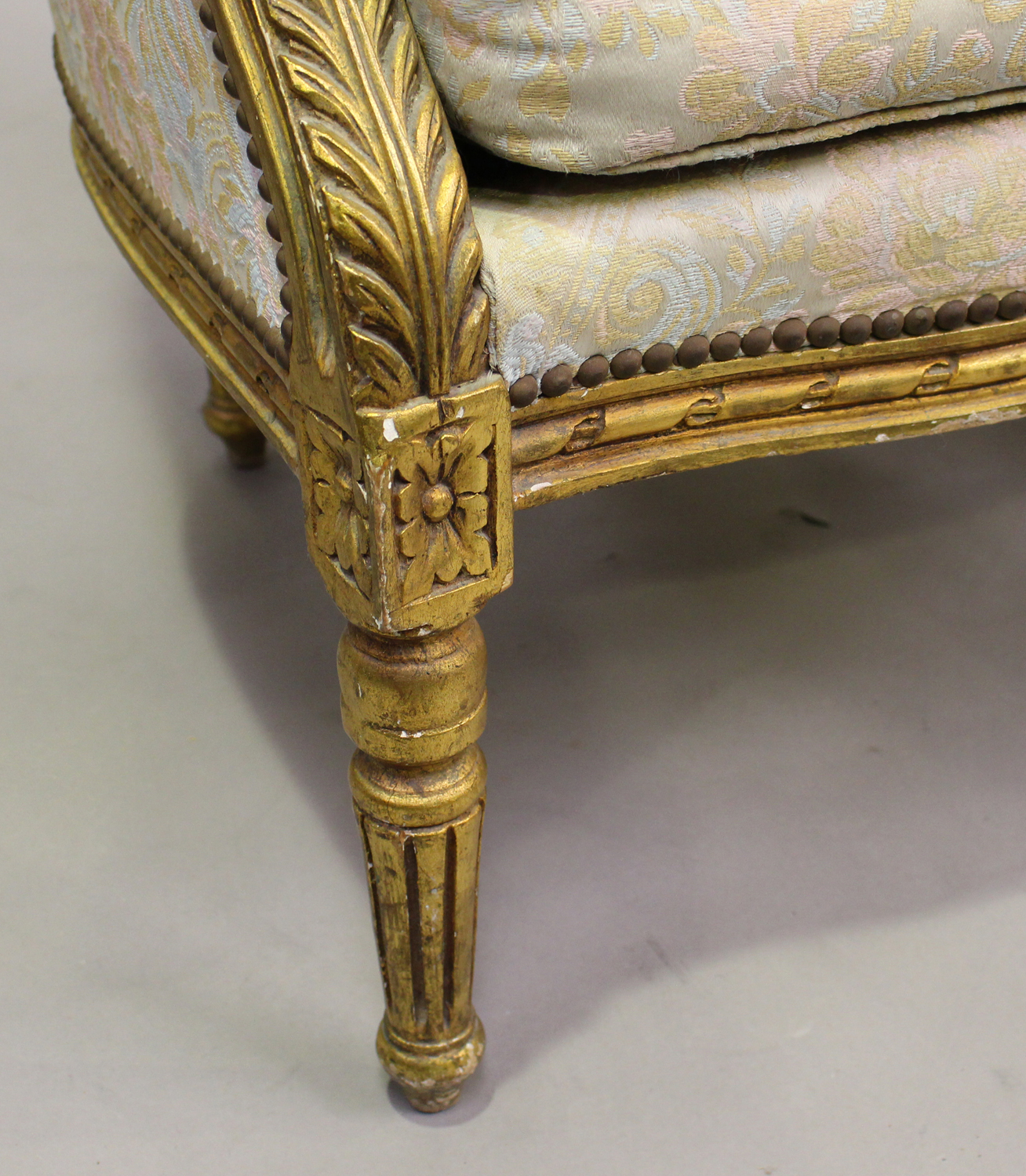 A pair of 20th century Louis XVI style giltwood showframe tub back armchairs, upholstered in foliate - Image 4 of 5