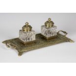 A late Victorian cast brass inkstand by William Tonks & Sons, fitted with a pair of reeded glass