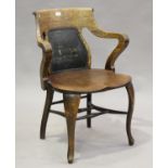 An Edwardian oak framed tub back desk chair with shaped seat panel and cabriole legs, height 85cm,
