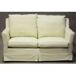 A modern cream fabric two-seat sofa by Multiyork, fitted with tailored removable covers, height