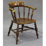 A mid-Victorian ash and elm tub back captain's chair, raised on turned legs, height 80cm, width