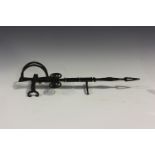 An unusual 19th century wrought iron long-handled fireside toaster with revolving end and scroll