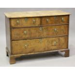 A George I walnut chest of two short and two long drawers with cross and feather banded borders,