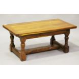 A late 20th century solid yew coffee table, on turned and block legs, height 46cm, length 108cm,