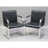 A pair of modern chromium plated metal and black leather cantilever armchairs, height 83cm, width