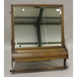 A late Victorian walnut bathroom wall mirror, fitted with a hinged compartment above a towel rail,