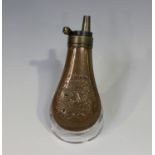 A Colt type reproduction pistol powder flask with eagle and star decoration, length 11.5cm.Buyer’s