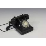 A mid-20th century 300 series black Bakelite telephone, the receiver numbered '164 49'.Buyer’s