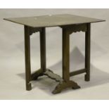 An early 20th century Jacobean Revival oak rectangular drop-flap table, on block legs and bracket